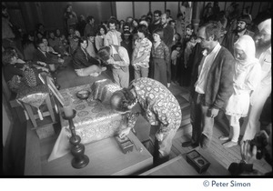 Ram Dass bending down at the altar during ritual