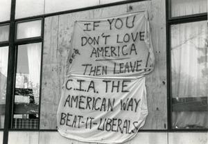 Banners hanging on building (possibly Beta Kappa Phi frat) at UMass Amherst reading 'If you don't love American then leave!' and 'CIA the American way, Beat it liberals'