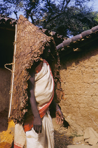Munda woman wearing a parasol woven from leafs