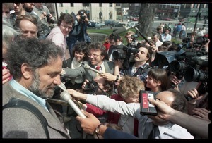 Scene outside the Hampshire County courthouse following acquittal in the CIA protest trial: Abbie Hoffman being interviewed by the press