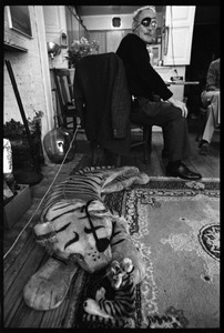 W. Eugene Smith, seated at a desk: view over stuffed toy tigers