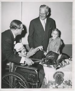 George Jessel and Bruce Barton helping clients carve Thanksgiving turkey