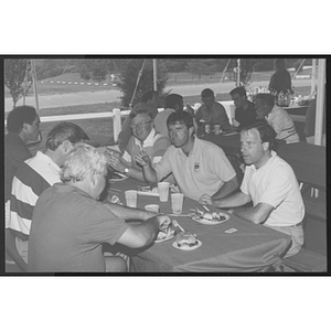 Adults eat together at a golf course