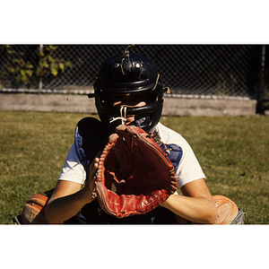 Child playing catcher in a baseball game