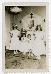 Children posing in front of altar