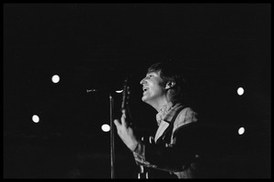 John Lennon (the Beatles) playing guitar and singing in concert at D.C. Stadium