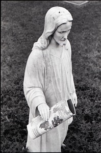 Statue of Jesus, copy of Free Spirit Press magazine set in his hand