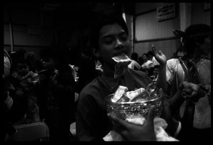 Cambodian New Year's celebration: drummer with money between his teeth and bowl