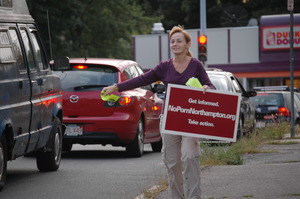 Protest against a pornographic video store in Northampton: protester with sign 'NoPornNorthampton.org,' handing out fliers to cars on North Street