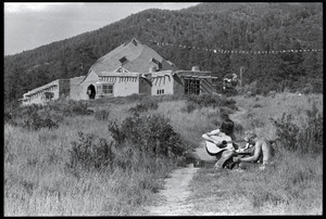 Lama Foundation Community: men playing guitar in the fields, the Dome in the background