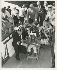 Children in wheelchairs on gangplank