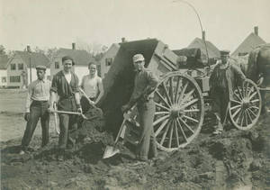 Workers spreading dirt on Pratt Field