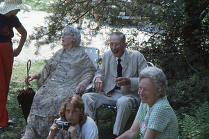 Mabel Cummings (far left) chats with Ella Rosenburg. Arthur Rosenburg (seated) behind Richard Ferris and his mother Martha Ferris (on right). Moon Barn Raising at entrance to Hopkins Forest on 2 August 1975.