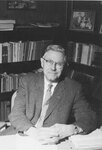 Suffolk University Vice President Donald W. Goodrich (1966-1969), seated at desk, photograph, circa 1960s