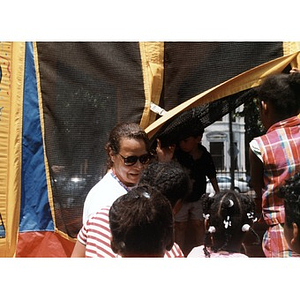 Woman supervises children entering a play tent at the 1999 Festival Betances.
