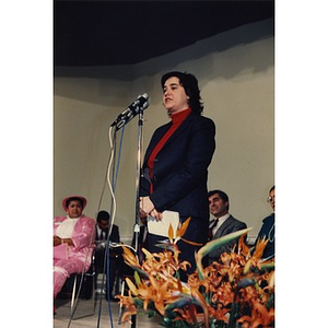 Woman addresses the audience during the opening of the Villa Victoria Cultural Center.