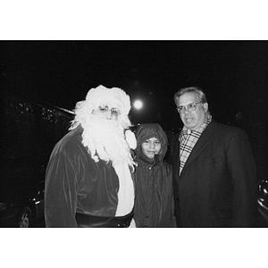 Mayor Menino, Santa Claus, and a child in a hood.
