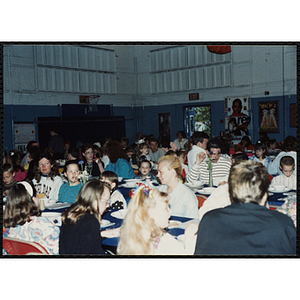 Children and adults sit together and converse during a Kiwanis Awards Night