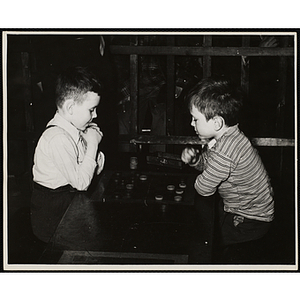 Two boys play checkers