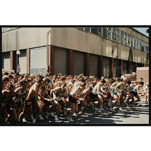 Runners dash from the start line of the Battle of Bunker Hill Road Race