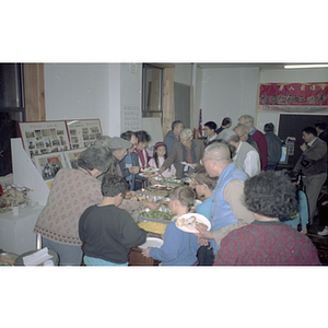 Guests eating during a Chinese Progressive Association anniversary event