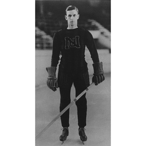 Unidentified hockey player poses on the ice