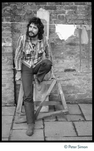 Cat Stevens: full-length portrait, seated by a laundry line on Carly Simon's patio