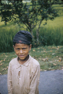 Poor rural child wearing a cap