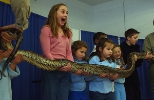 Cranston students hold a Burmese python