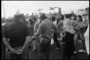 Escorts ushering a woman past police and pro-life protesters into the Providence Planned Parenthood clinic