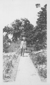 F. A. Waugh walking along a garden path