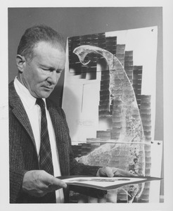Harold Theodore Uhr Smith studying photograph