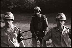 Antiwar demonstration at Fort Dix, N.J.: military police standing by, one in a gas mask