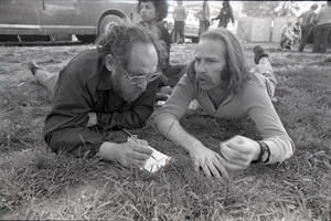 May Day concert and demonstrations: Stuart Werbin (r) lying in the grass, talking to another man