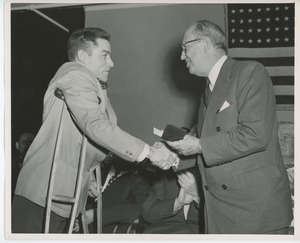 Jeremiah Milbank, Sr. handing wallet to a graduate