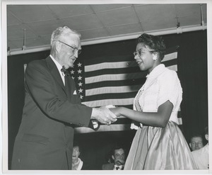 Bruce Barton shaking hands with client at Institute Day