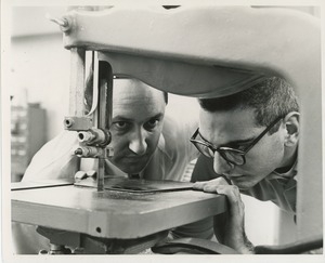 Ed Rossi watching Donald Meisler operate bandsaw