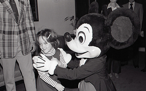 Child with Disney character Mickey Mouse