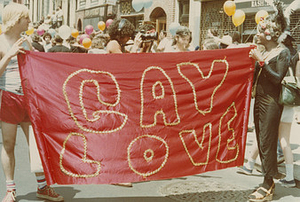 Marsha P. Johnson holding a banner at Christopher Street Liberation Day Parade 1977