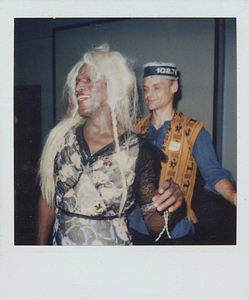 A Photograph of Marsha P. Johnson with Blonde Hair and a Black and Pink Patterned Dress, Dancing with Another Person
