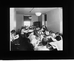 Boys reading and playing indoors