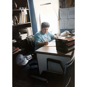 Inquilinos Boricuas en Acción employee Carmen Colombani working at her desk.