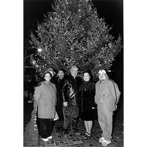 Mayor Menino with Inquilinos Boricuas en Acción board members posing before a large Christmas tree.