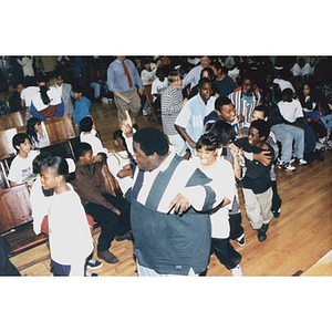 School children dancing in the aisles of their school auditorium during an Areyto-sponsored program.