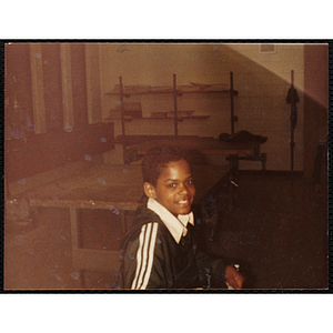 An African American boy smiles for the camera during a class at the Boys and Girls Club