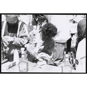 A woman puts ketchup on a hot dog at the Boys and Girls Clubs of Boston 100th Anniversary Celebration Street Fair