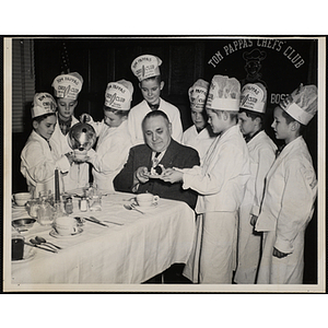 "Bunker Hill Boy's Club played host to the Charlestown Lions Club. President Henry Keridal receives delicious dessert after a mighty fine dinner prepared by these boys"