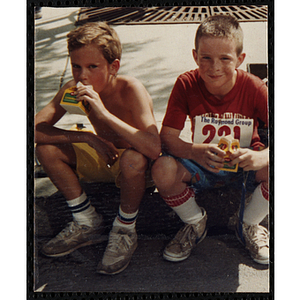 Two boys enjoy drinks during the Battle of Bunker Hill Road Race