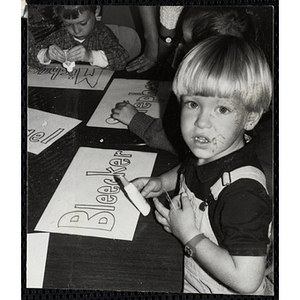 A Young boy working on an art project