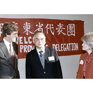 U.S. Senator John Kerry stands with an unidentified woman and a member of the Guangdong Province delegation upon his arrival in Boston